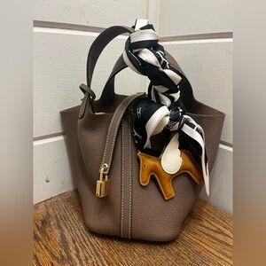 Elegant brown leather bucket bag with lock
